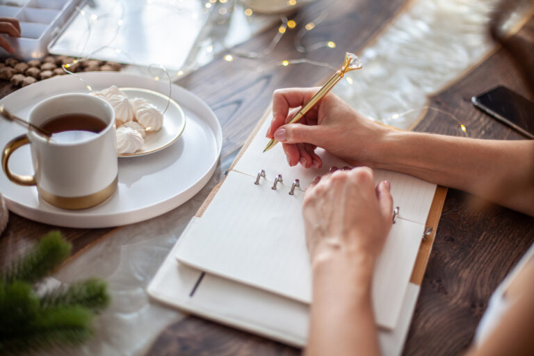 A woman planning out her day on a notepad, which helps her get the most out of planning