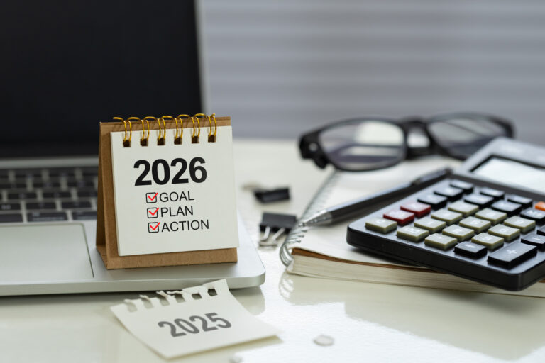 Desk calendar 2026 with checklist Goal, Plan, Action on office workspace beside calculator, notebook, pen and laptop, represent planning and budgeting